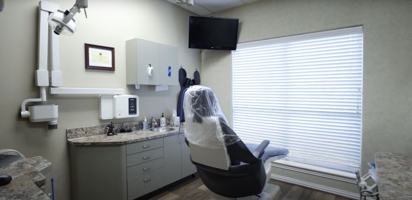Dental treatment room with a T V mounted on the wall