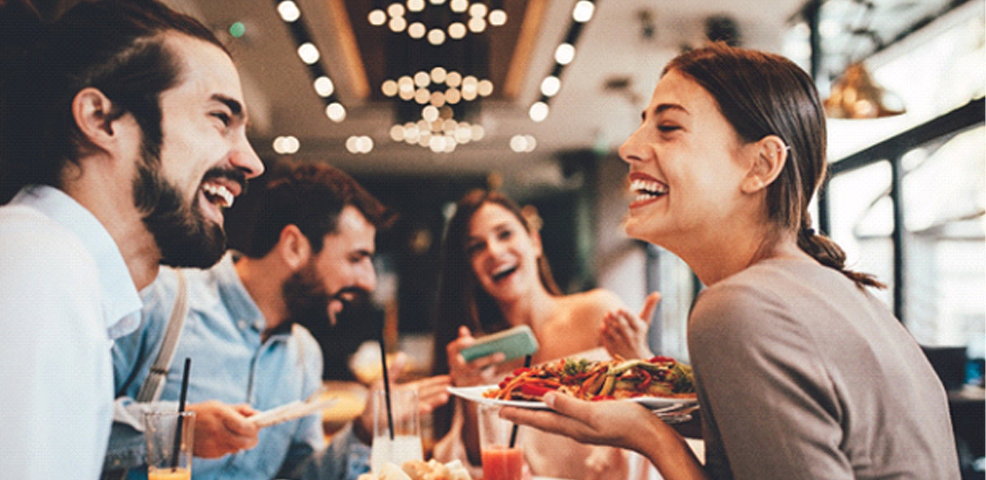 Baytown patient smiling with friends at restaurant
