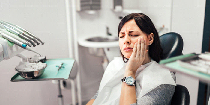 A woman at the dentist with a toothache