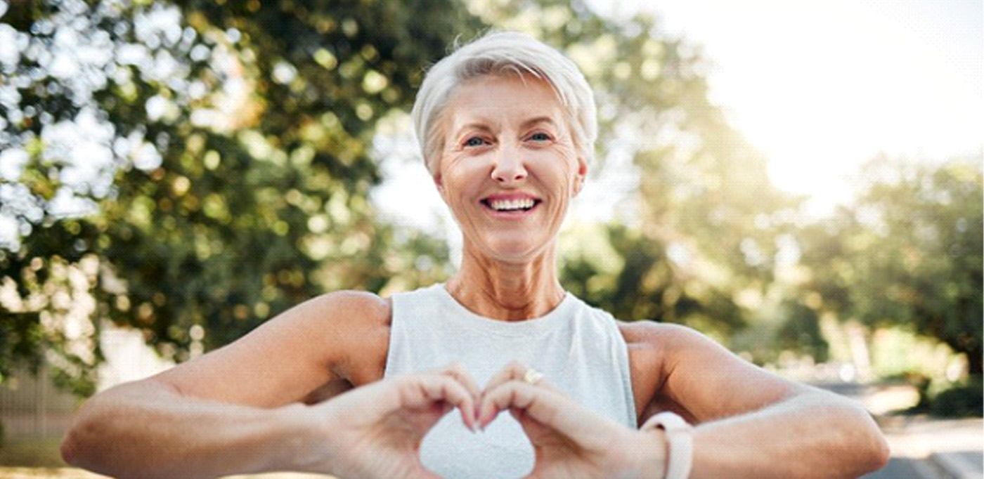 Lady makes shape of heart with her hands
