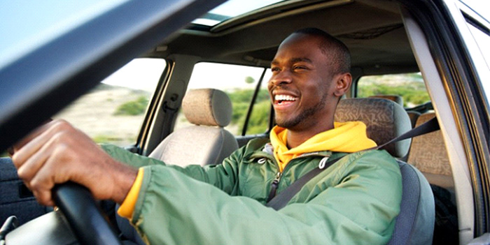 Man smiles while driving