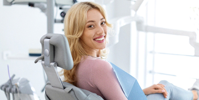 Patient smiling while sitting in treatment chair