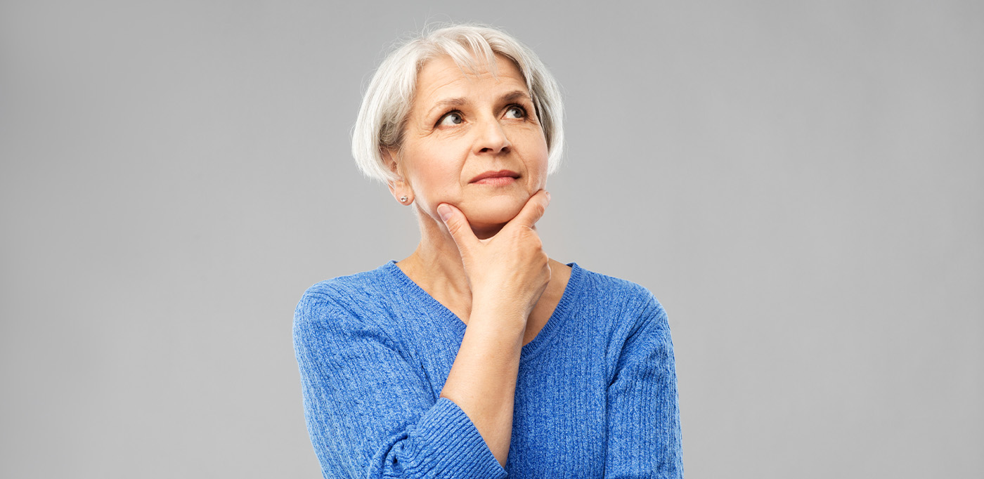 Woman rubbing her chin in a questioning pose