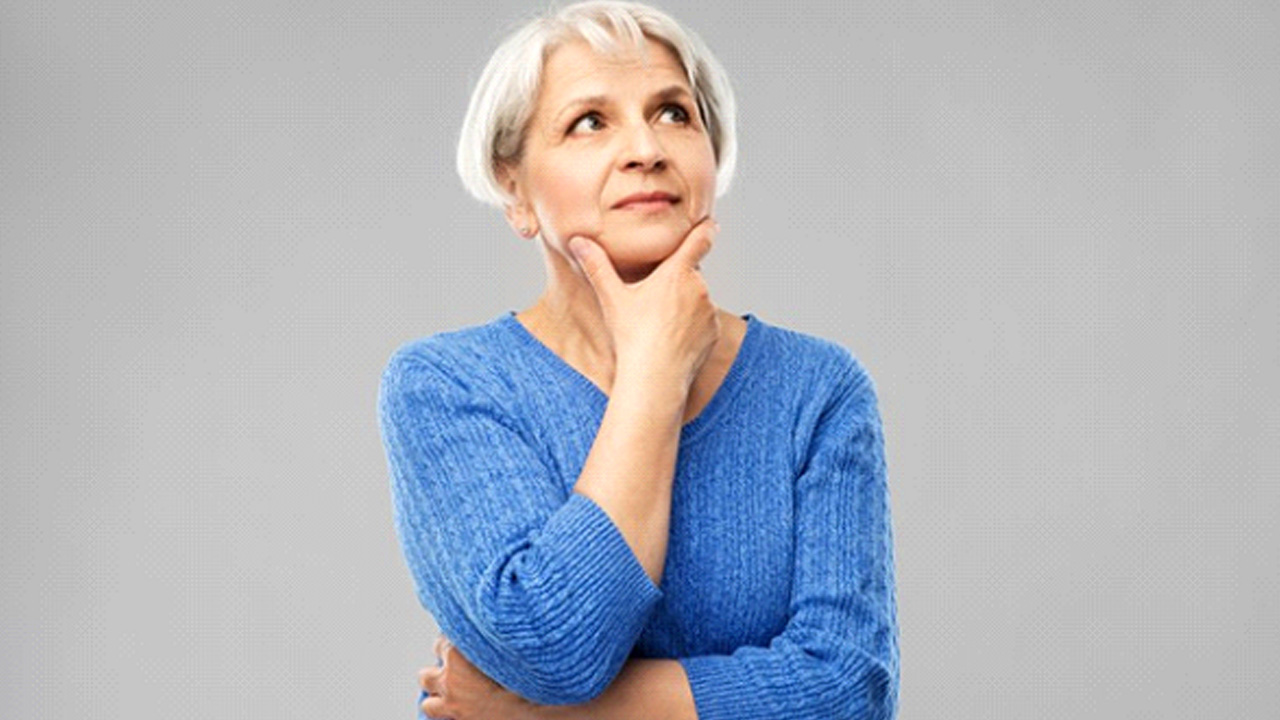 Woman rubbing her chin in a questioning pose