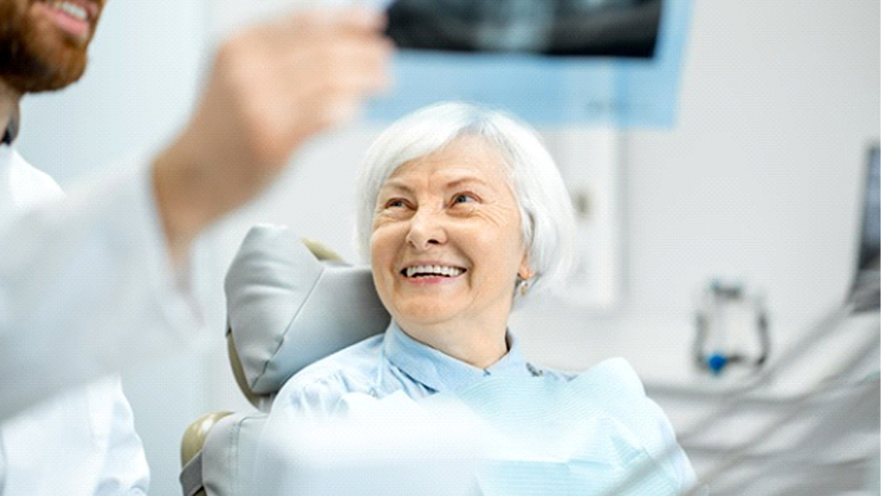 Dentist reviewing an X-ray with his patient