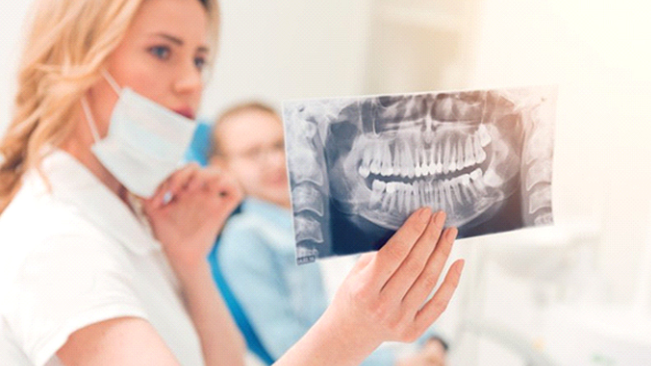 Dentist showing a patient his X-ray
